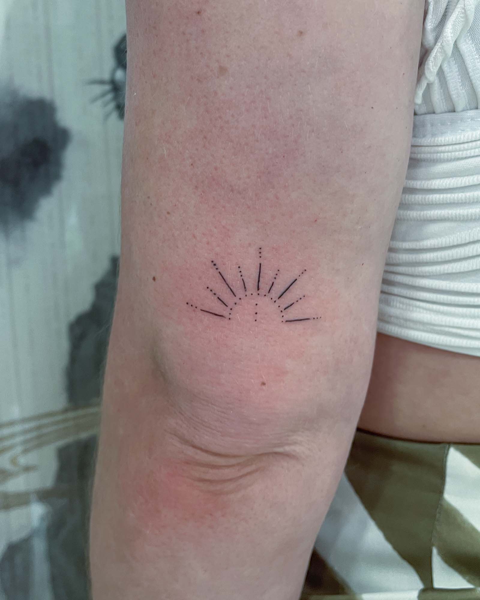 Minimalist fine line clover tattoo with a simple and delicate design.