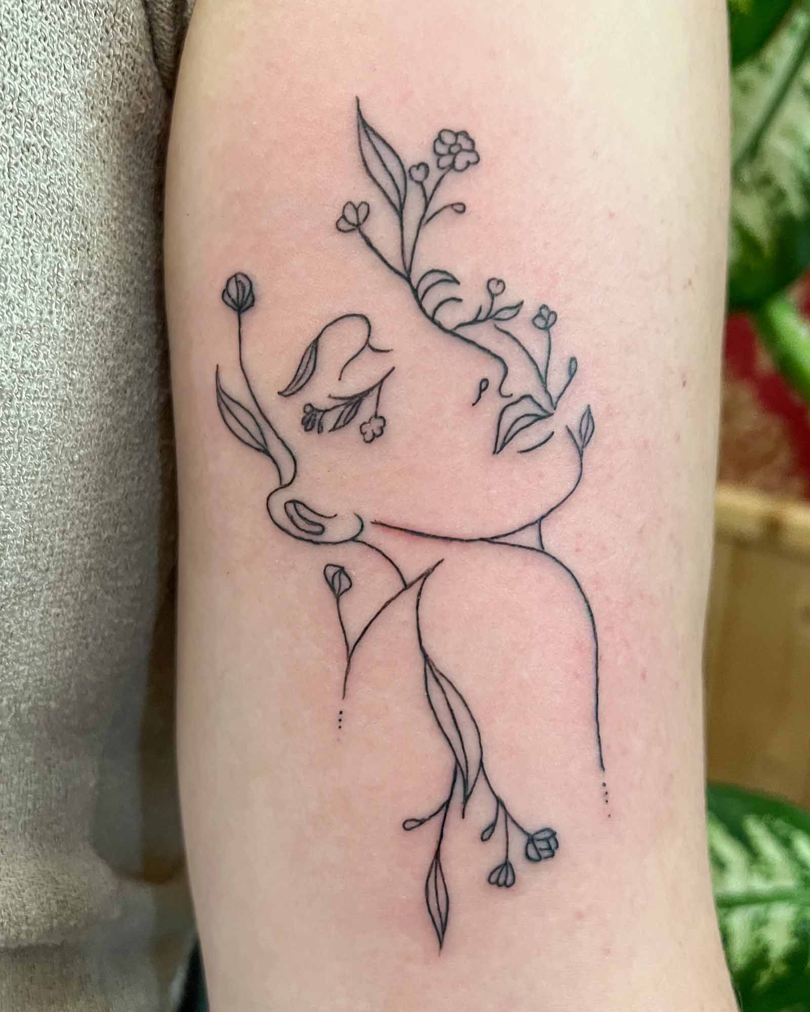 fine line female face flower tattoo valencia