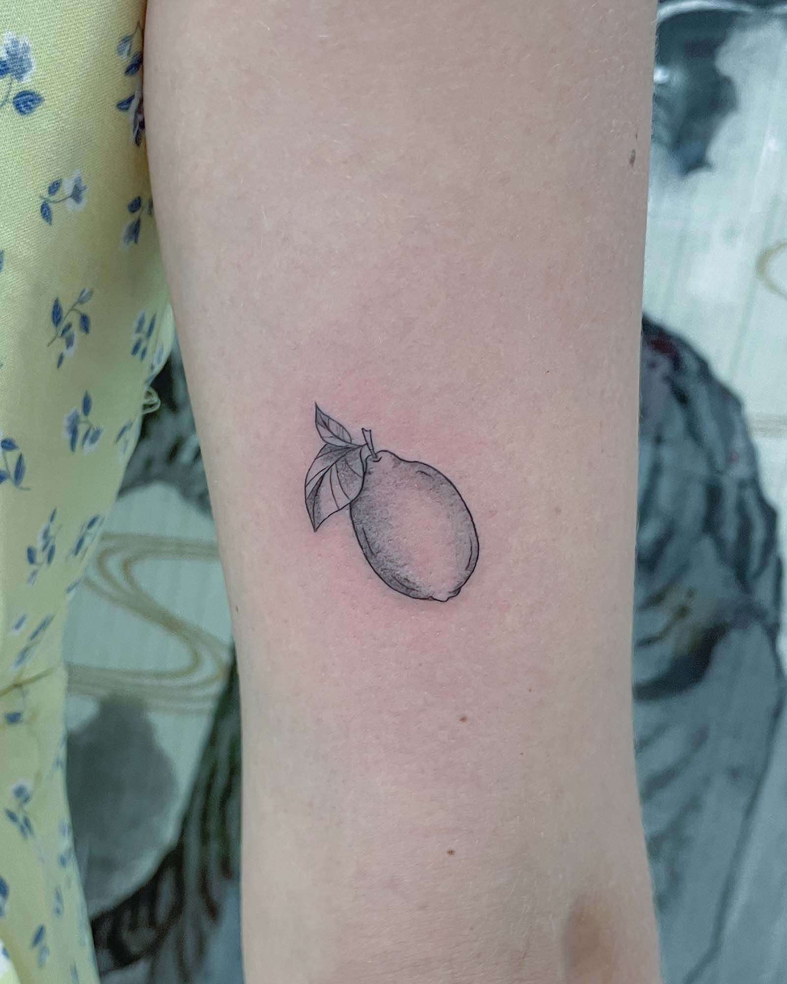 fine line lemon tattoo valencia small minimalist fruit tattoo simple citrus design
